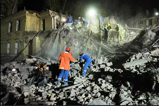 Ukrainian rescuers operate at the site of a Russian missile attack in Kyiv on April 24, 2025