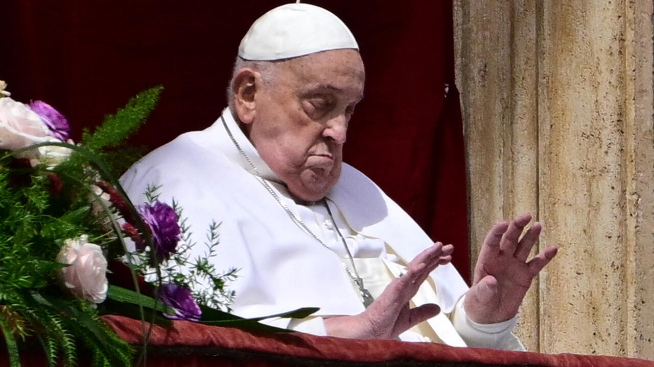 Pope Francis waves from the main balcony of St. Peter's basilica for Easter celebrations on April 20, 2025.